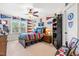 Charming bedroom featuring fan, window, built-ins, sports decor, and carpeted floor at 50 Lockamy Ln, Youngsville, NC 27596