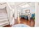 Bright dining room with wood floors, chandelier lighting, and a view of the living area at 50 Lockamy Ln, Youngsville, NC 27596