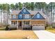 Charming two-story home with stone accents, covered porch, and attached two-car garage at 50 Lockamy Ln, Youngsville, NC 27596