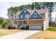 Charming two-story home featuring a covered front porch, a side-entry garage, and mature trees at 50 Lockamy Ln, Youngsville, NC 27596