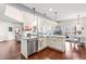 Open kitchen with large island and stainless steel appliances leads to the living room with fireplace at 50 Lockamy Ln, Youngsville, NC 27596