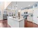Modern kitchen with stainless steel appliances, an eat-in island, and an adjacent breakfast nook at 50 Lockamy Ln, Youngsville, NC 27596