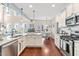 Spacious kitchen with a central island, stainless appliances, and seamless flow to the living area at 50 Lockamy Ln, Youngsville, NC 27596