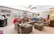 Comfortable living room featuring sectional sofa, neutral tones, large windows, and gaming area at 50 Lockamy Ln, Youngsville, NC 27596