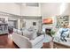 Open-concept living area with fireplace, hardwood floors, and view of the dining room and stairs at 50 Lockamy Ln, Youngsville, NC 27596