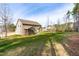 Expansive lawn and rear exterior view of the home featuring a patio and screened in porch at 50 Lockamy Ln, Youngsville, NC 27596