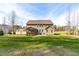 Rear exterior view of the home with a back patio and screened in porch overlooking a large lawn at 50 Lockamy Ln, Youngsville, NC 27596