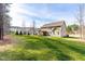 Backyard view of the home featuring a large lawn, patio and screened in porch at 50 Lockamy Ln, Youngsville, NC 27596