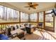 Comfortable screened porch featuring a ceiling fan, comfortable seating and a beautiful wooded backyard at 50 Lockamy Ln, Youngsville, NC 27596