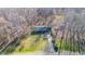 Aerial view of a charming home surrounded by trees and a well-manicured lawn at 501 Orange High School Rd, Hillsborough, NC 27278