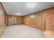 Partially finished basement with brick accents and access to storage and utility areas at 501 Orange High School Rd, Hillsborough, NC 27278