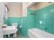 Retro-style bathroom with green tiles, classic fixtures, and a tub-shower combo at 501 Orange High School Rd, Hillsborough, NC 27278