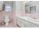 Vintage bathroom with pink tiles, double vanity, and ample lighting at 501 Orange High School Rd, Hillsborough, NC 27278