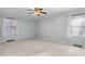 Bright bedroom featuring soft carpet, large windows, and neutral paint at 501 Orange High School Rd, Hillsborough, NC 27278