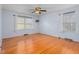 Spacious bedroom with hardwood floors, bright windows, and a ceiling fan at 501 Orange High School Rd, Hillsborough, NC 27278