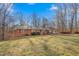 Charming brick ranch home featuring red shutters and a well-maintained front yard in a tranquil setting at 501 Orange High School Rd, Hillsborough, NC 27278