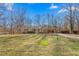 A well-maintained single story home featuring a paved driveway and large front lawn at 501 Orange High School Rd, Hillsborough, NC 27278