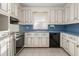 Bright kitchen featuring white cabinets, stainless steel appliances, and blue countertops at 501 Orange High School Rd, Hillsborough, NC 27278