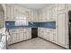 Charming kitchen with white cabinets, blue countertops, and ample storage at 501 Orange High School Rd, Hillsborough, NC 27278