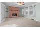 Inviting living room featuring a brick fireplace and carpet floors with open french doors to another room at 501 Orange High School Rd, Hillsborough, NC 27278