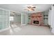 Bright living room featuring a brick fireplace and seamless carpet flooring at 501 Orange High School Rd, Hillsborough, NC 27278