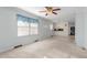 Inviting interior space with large windows, carpet floors, and seamless access to the kitchen at 501 Orange High School Rd, Hillsborough, NC 27278