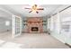 Cozy living room featuring a brick fireplace with open access through french doors to another room at 501 Orange High School Rd, Hillsborough, NC 27278