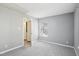 This bedroom is bright and airy with neutral paint, carpet, and a large window at 509 High Ridge Dr, Durham, NC 27707