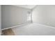 Bright bedroom with neutral gray carpet, light gray walls, and a large window at 509 High Ridge Dr, Durham, NC 27707