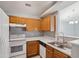 Well-maintained kitchen with white appliances, oak cabinetry, and an open layout at 509 High Ridge Dr, Durham, NC 27707