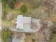 A peaceful residence with a gravel driveway and a mix of flowering trees and mature trees at 513 N Nash St, Hillsborough, NC 27278