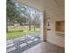 Covered back porch with brick accent wall and decorative stone flooring at 513 N Nash St, Hillsborough, NC 27278