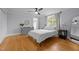 Cozy bedroom with hardwood floors, a ceiling fan, and a comfortable bed at 513 N Nash St, Hillsborough, NC 27278