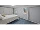 Cozy bedroom with blue carpeting, built-in wardrobe, and natural light from two windows at 513 N Nash St, Hillsborough, NC 27278