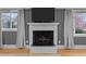 Living room fireplace with white mantel and mounted television at 513 N Nash St, Hillsborough, NC 27278