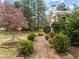 Charming walkway leading to the front of this home with a beautiful yard and landscaping at 513 N Nash St, Hillsborough, NC 27278