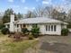 Attractive white brick home with a red front door, and landscaped front yard at 513 N Nash St, Hillsborough, NC 27278