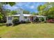 A beautifully landscaped front yard is showcased in this photograph, featuring mature bushes and a freshly cut lawn at 513 N Nash St, Hillsborough, NC 27278