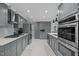 Spacious kitchen showcasing sleek gray cabinets, stainless steel appliances, and an abundance of storage space at 513 N Nash St, Hillsborough, NC 27278