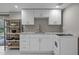 Basement kitchenette with white cabinets, marble countertops, and stainless appliances at 513 N Nash St, Hillsborough, NC 27278