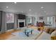 Warm living room featuring a fireplace, hardwood floors, and a comfortable couch at 513 N Nash St, Hillsborough, NC 27278