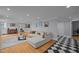 Bright, spacious living room boasts hardwood floors, modern decor, and lots of natural light at 513 N Nash St, Hillsborough, NC 27278