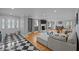Spacious living room featuring hardwood floors, a fireplace, and a stylish black and white tiled entryway at 513 N Nash St, Hillsborough, NC 27278