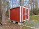 Red storage shed for tools and equipment with access to the backyard at 513 N Nash St, Hillsborough, NC 27278
