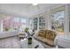 Inviting sunroom filled with natural light and wicker furniture at 513 N Nash St, Hillsborough, NC 27278