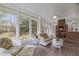 Bright sunroom with lots of windows and brick fireplace at 513 N Nash St, Hillsborough, NC 27278