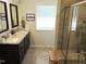 Bathroom showcases a double sink vanity, granite countertops, and a framed mirror above each sink at 519 Flat Ford Rd, Hillsborough, NC 27278