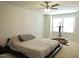 Spacious bedroom features a ceiling fan, a large window and minimal decor, showcasing its potential at 519 Flat Ford Rd, Hillsborough, NC 27278
