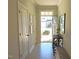 Bright entryway with white walls, light wood floors, and a view to the front door at 519 Flat Ford Rd, Hillsborough, NC 27278