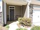 Exterior view of a townhome's front door, featuring stone accents and landscaping at 519 Flat Ford Rd, Hillsborough, NC 27278